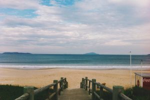 Empty ocean beach; image by Beto Galetto, via Unsplash.com.