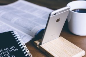 Silver iPhone 6 on rack; image by Freestocks, via Unsplash.com.