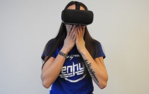 Woman using black VR headset; image by Hammer and Tusk, via Unsplash.com.