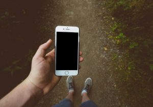 Person holding silver iPhone 6 with black case; image by Jamie Street, via Unsplash.com.