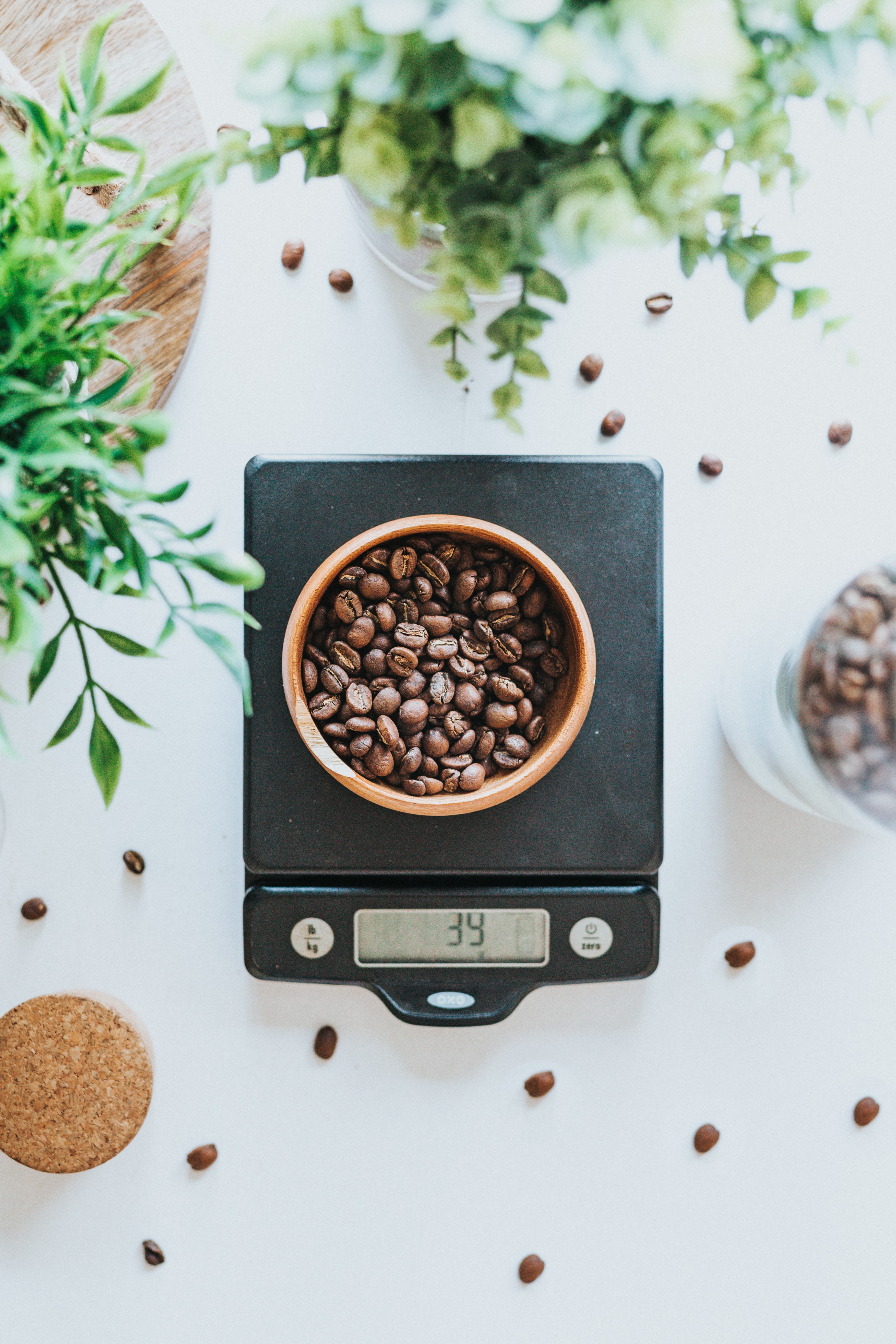Bowl filled with coffee beans on black digital scale at 39 grams; image by Tyler Nix, via Unsplash.com.