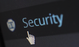 Upclose shot of computer screen with the word “Security” and a hand-shaped cursor; image by Pixabay, via Pexels.com.