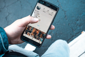 Man using Instagram on a smartphone; image by Erik Lucatero, via Unsplash.com.