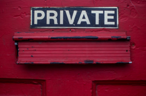 Red door with mail slot and sign saying “Private.” Image by Dayne Topkin, via Unsplash.com.