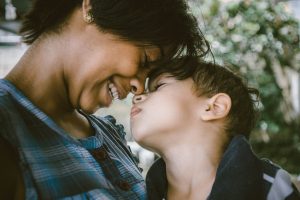 Woman and child touching faces, image by Bruno Nascimento, via Unsplash.com.