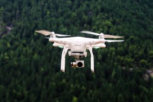 White drone, mid-flight; image by Jason Blackeye.