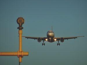 Plane landing at London Heathrow Airport; image by Sebastian Grochowicz, via Unsplash.com.