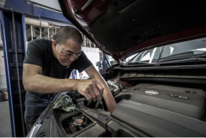 Mechanic working on car; image by DokaRyan, via Pixabay.com.