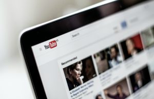 Up-close photo of YouTube on a smartphone; image by NordWood Themes, via Unsplash.con.