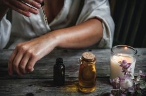 Person applying oil to skin of arm; image by Chelsea Shapouri, via Unsplash.com.