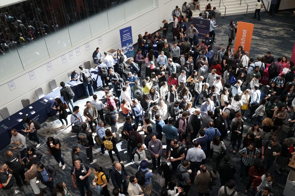 Crowd of people in building lobby; image by Product School, via Unsplash.com.