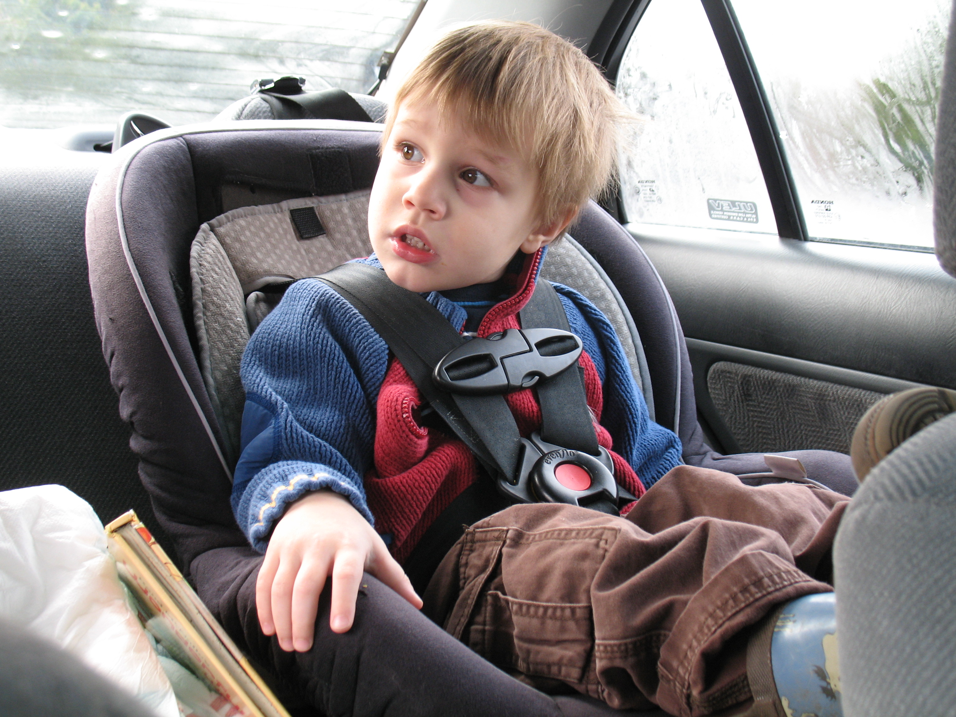 Young boy in a car seat; image by xordroyd, via Flickr, CC BY-SA 2.0, no changes.