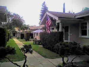 Small homes surrounding a narrow, green common space.