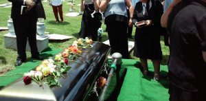 Casket surrounded by mourners