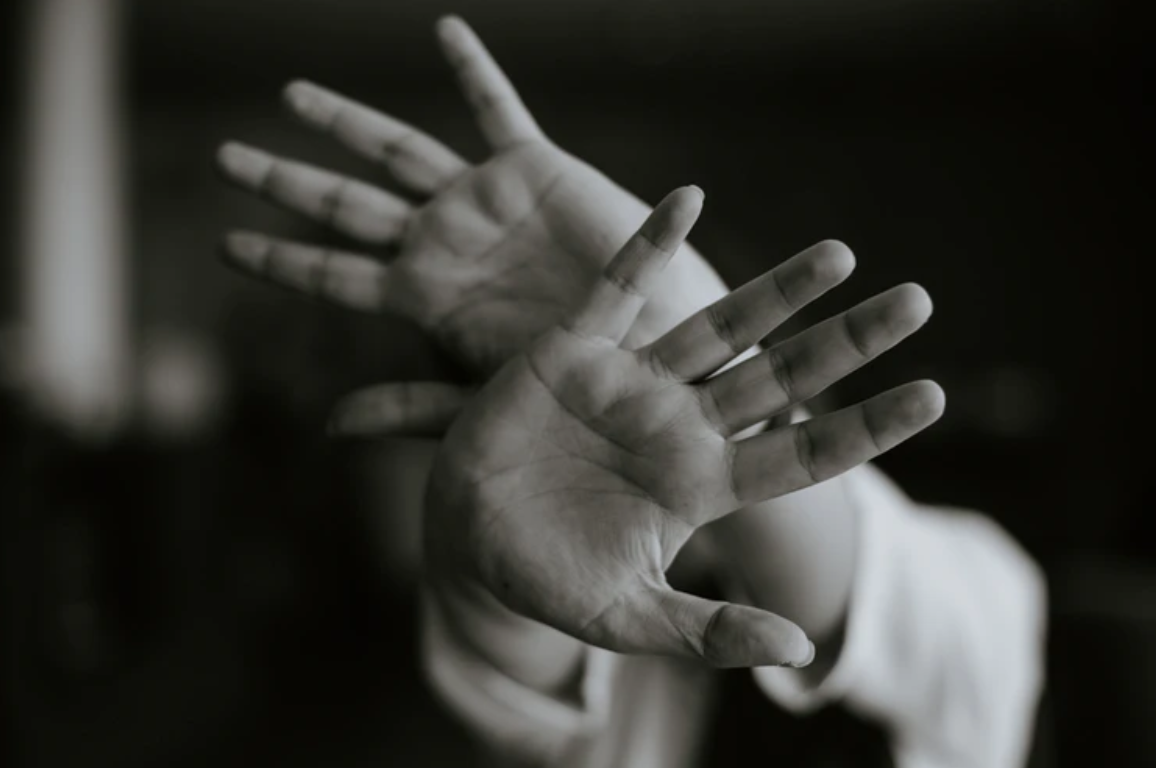 Woman holding both hands out, palms first; image by M.T ElGassier, via Unsplash.com.