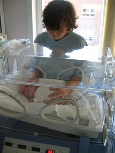 Mother comforting premature baby