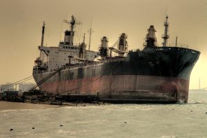 Large abandoned ship under an overcast sky.