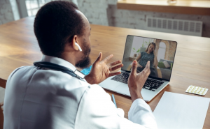 Doctor advising patient via laptop telemedicine; image by Master1305, via Freepik.com.