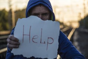 Man holding a help sign