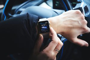 Driver with an Apple Watch; image by Luca Bravo, via Unsplash.com.