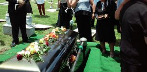 People gathered graveside for burial; image by Rhodi Lopez, via Unsplash.com.