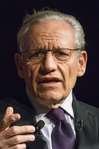 Head and shoulders portrait of an older man in a suit.