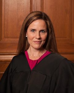 A woman with long hair wearing a black robe.