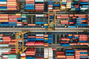 Aerial view of shipping containers; image by Chuttersnap, via Unsplash.com.