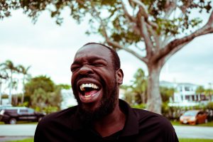 Man laughing; image by Brian Lundquist, via Unsplash.com.