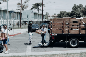 Volunteers unloading a truck; image by Joel Muniz, via Unsplash.com.