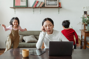 Children disturbing mother who is working from home; image by Ketut Subiyanto, via Pexels.com.