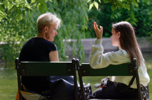 Mother and daughter speaking; image by Candid_Shots, via Pixabay.com.