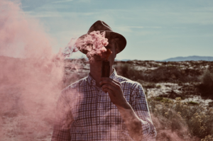 Man vaping outdoors, clouds of vapors; image by StockSnap, via Pixabay.com.