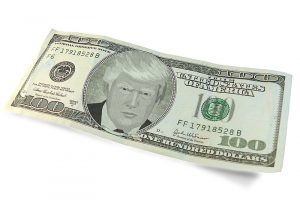 A $100 bill with Trump's likeness in the center.