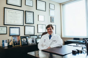 Doctor seated at desk; image by LinkedIn Sales Navigator, via Pexels.com.