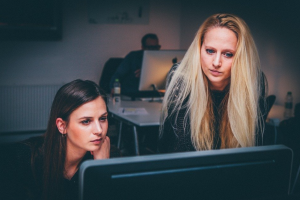 Two women looking at computer monitor; image by Free-Photos, via Pixabay.com.