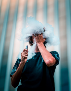 Man vaping with heavy clouds of vapor; image by Nathan Salt, via Pexels.com.