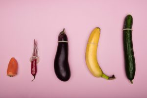 Various fruits and vegetables wearing condoms; image by Deon Black, via Unsplash.com.