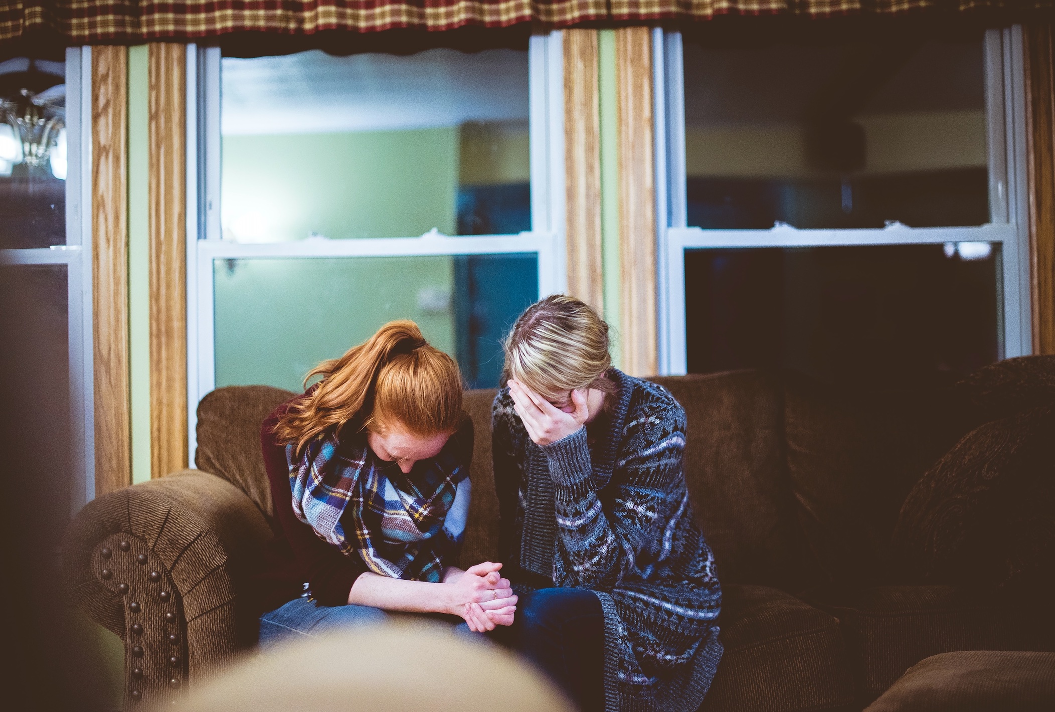 Two women on sofa; image by Ben White, via Unsplash.com.