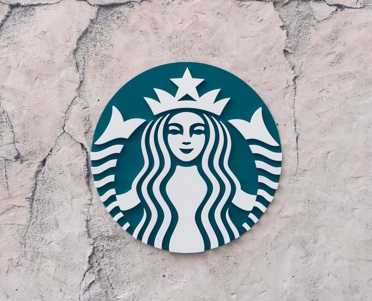 Iconic Starbucks logo on a cracking, decaying background.