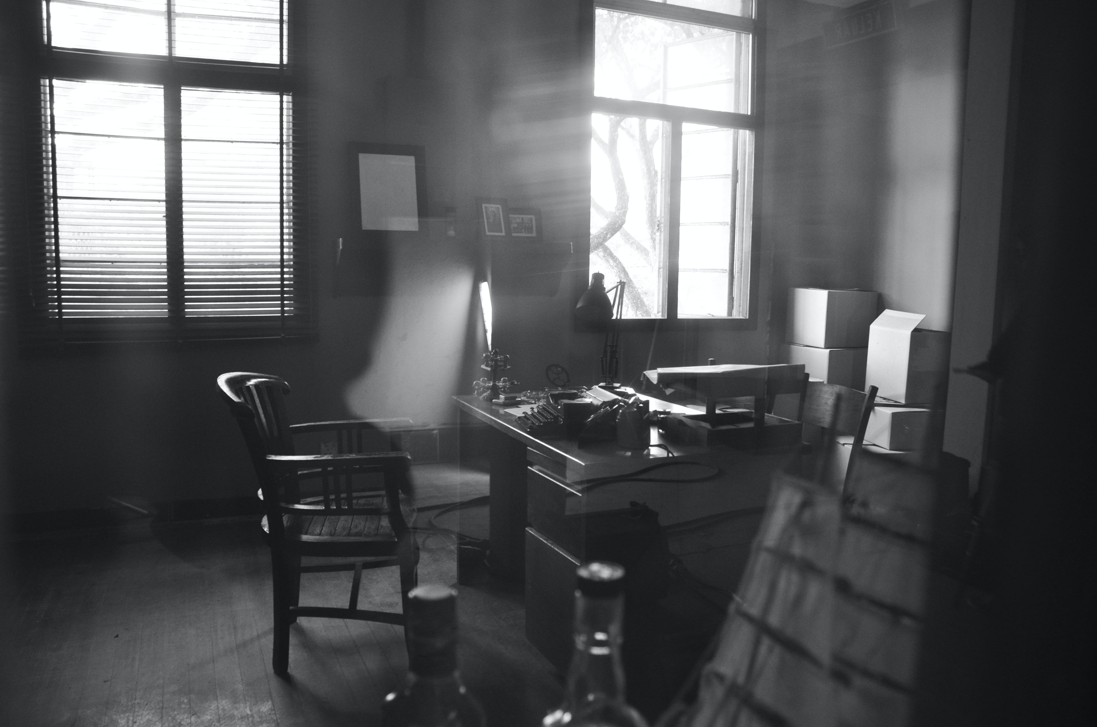 Black and white shot of investigator's office; image by Michelle Ding, via Unsplash.com.