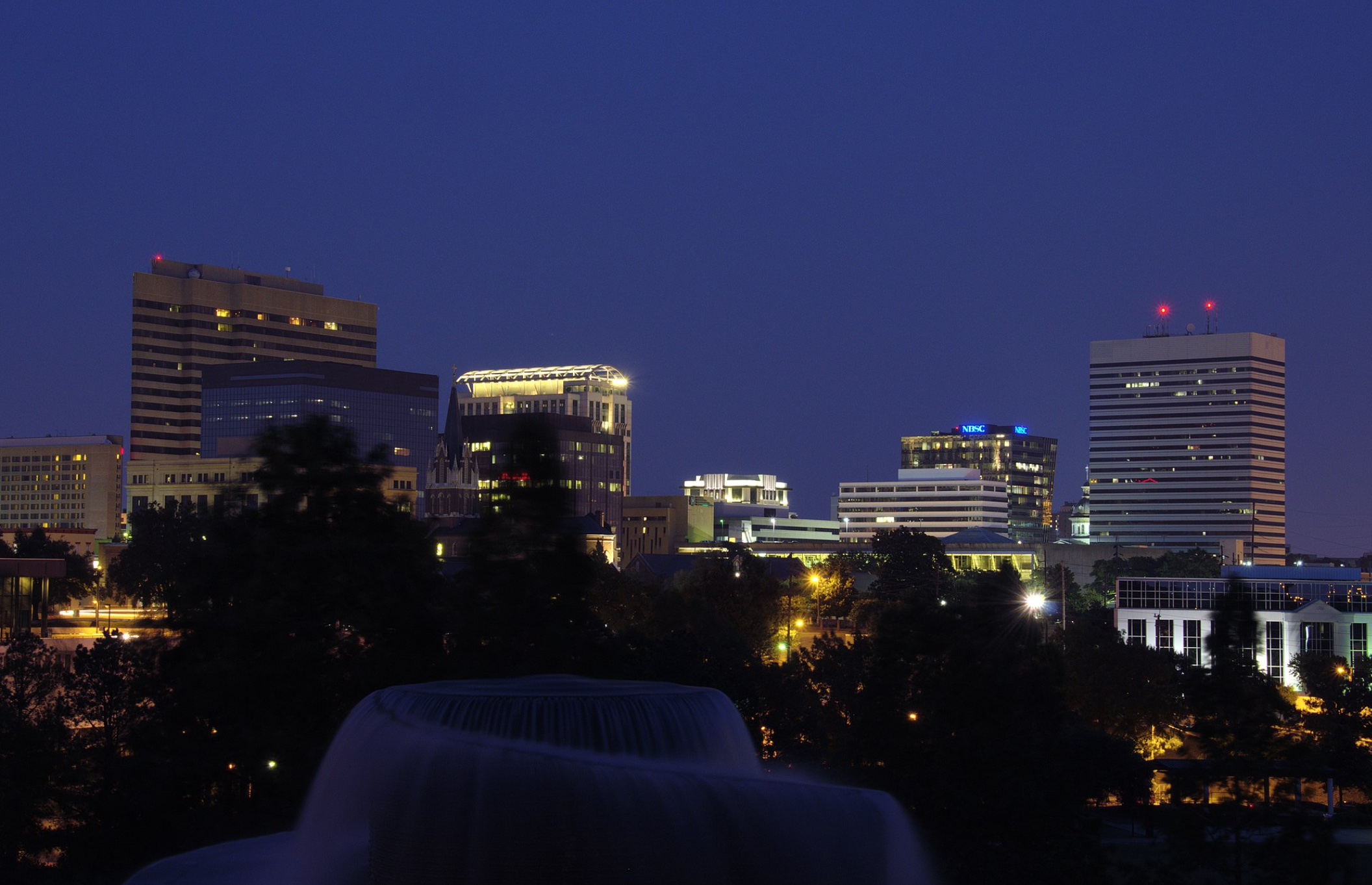 Columbia, SC skyline at night; image by Tim from Atlanta, USA, CC BY 2.0, via Wikimedia Commons.