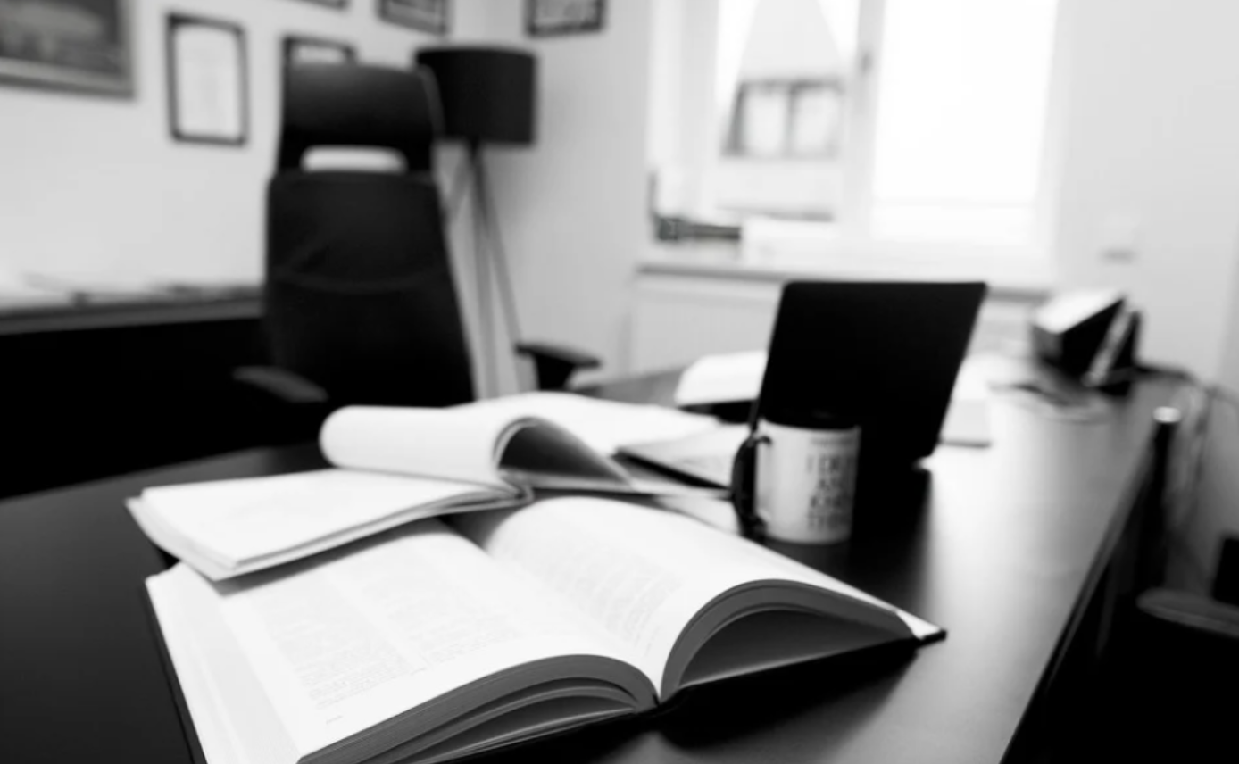 Executive desk with books; image by Rastaemmler, via Pixabay.com.