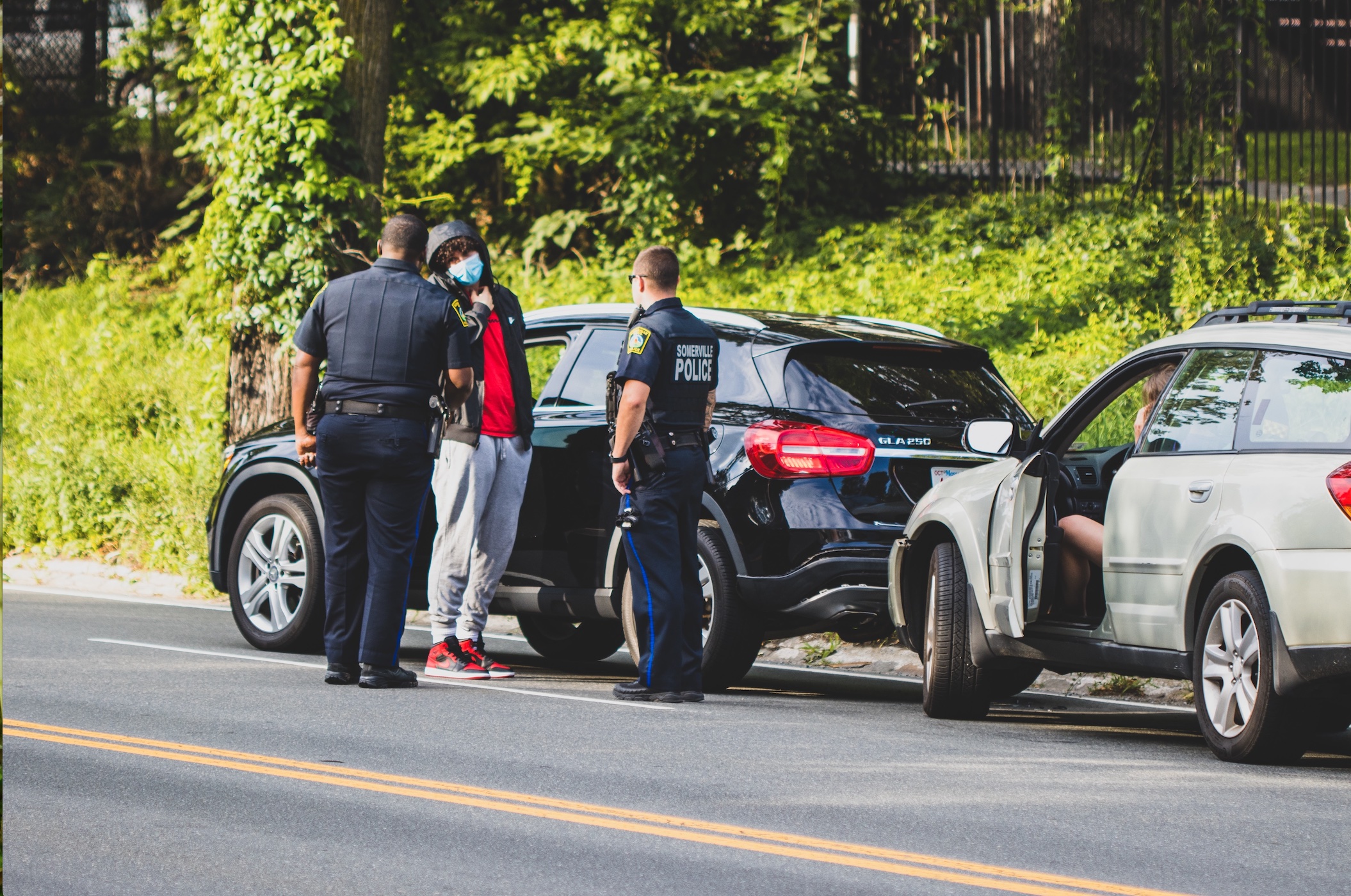 Minor car accident, police on the scene; image by Aaron Doucett, via Unsplash.com.
