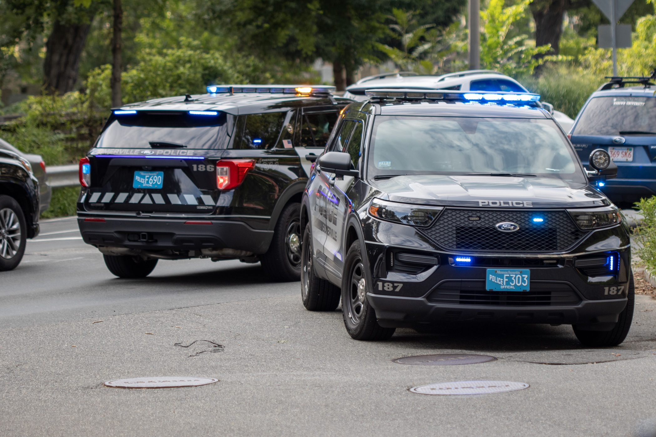 Police vehicles on scene at accident; image by Aaron Doucett, via Unsplash.com.
