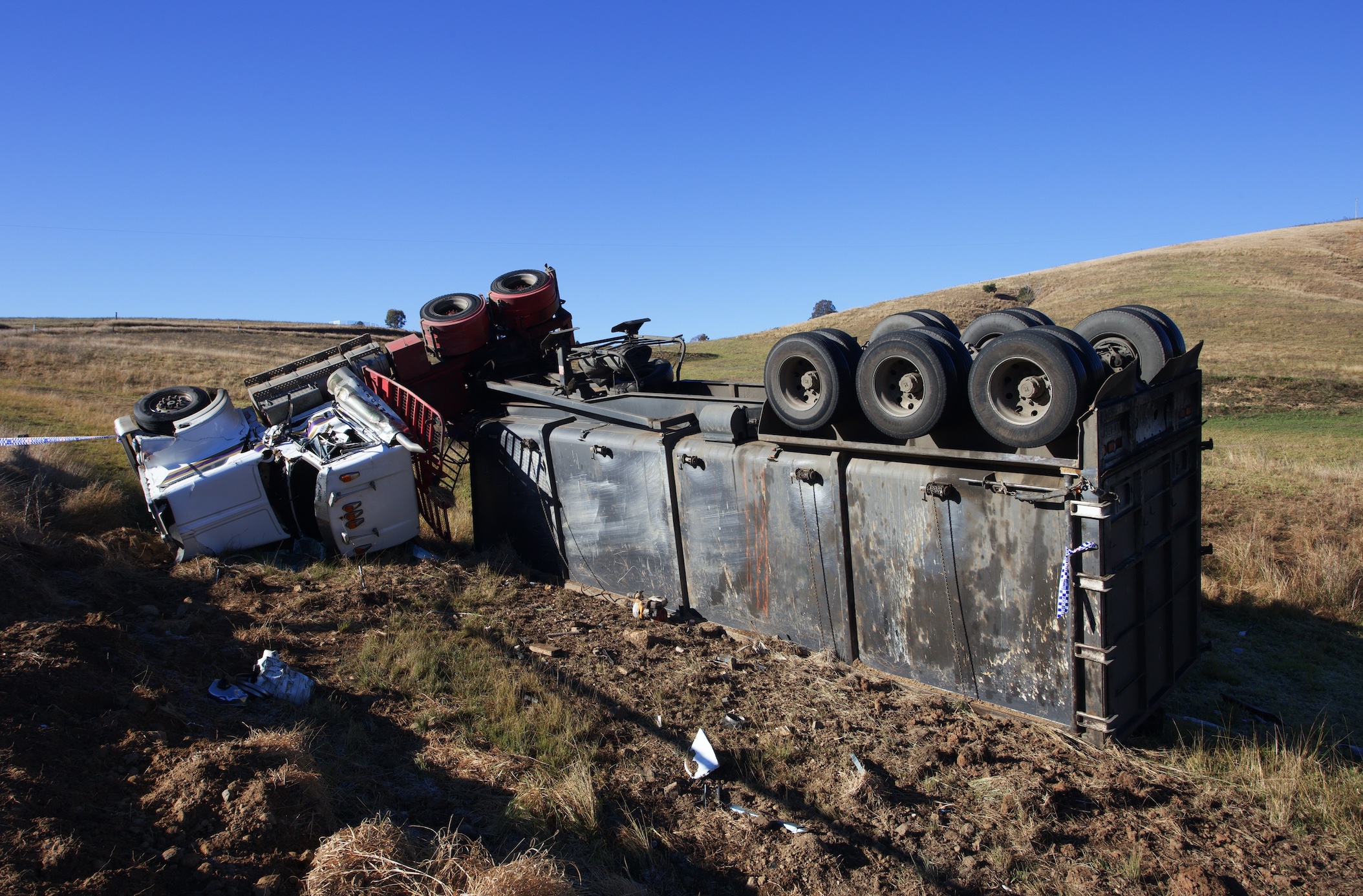 Semi-truck rolled over; image by Stephen Tafra, via Unsplash.com.