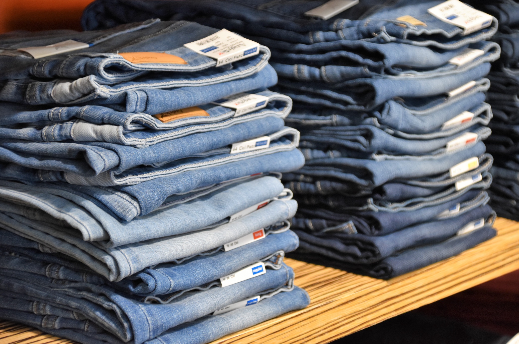 Stacks of blue jeans; image by Waldemar Brandt, via Unsplash.com.