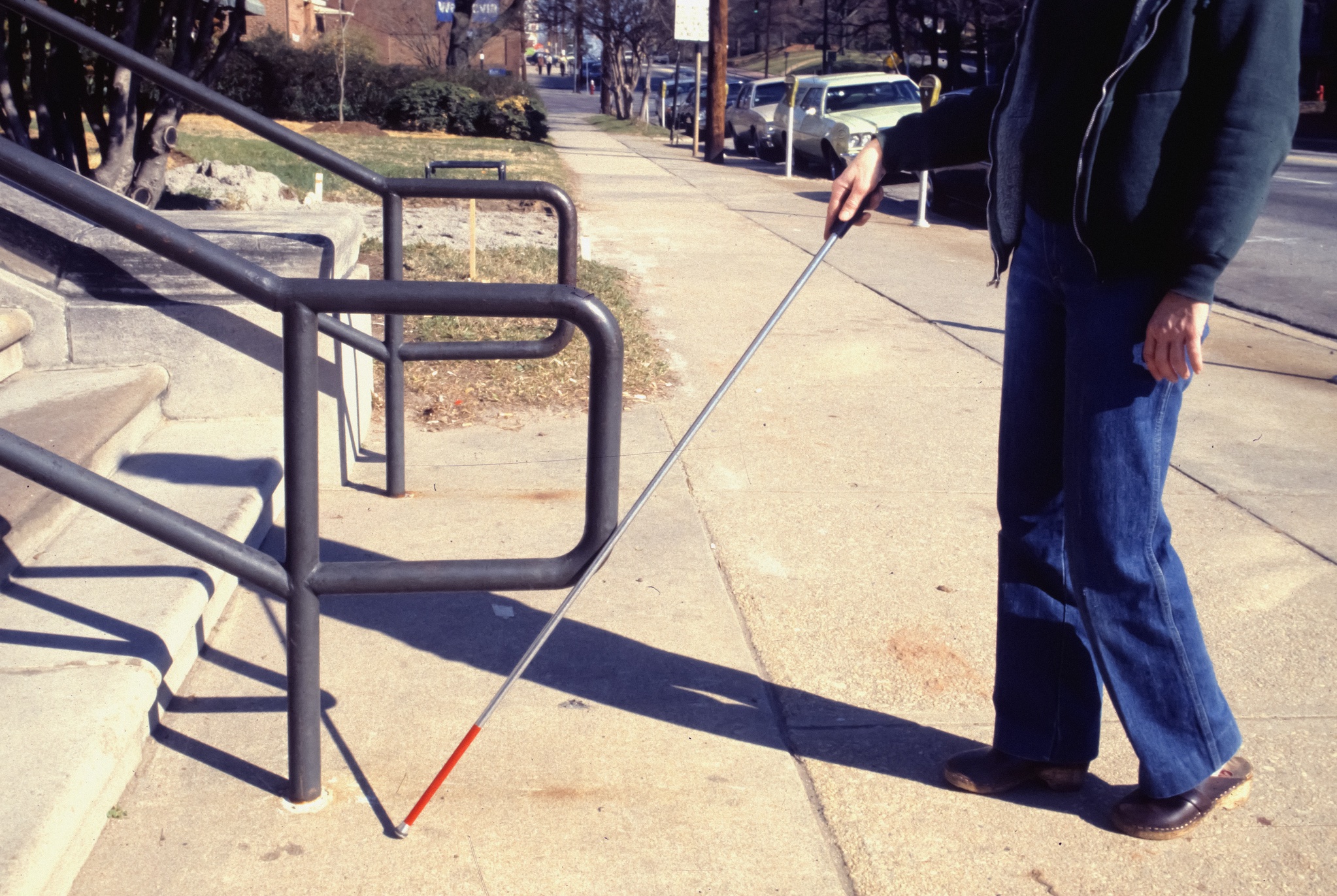 Visually impaired man using a walking stick; image by CDC, via Unsplash.com.