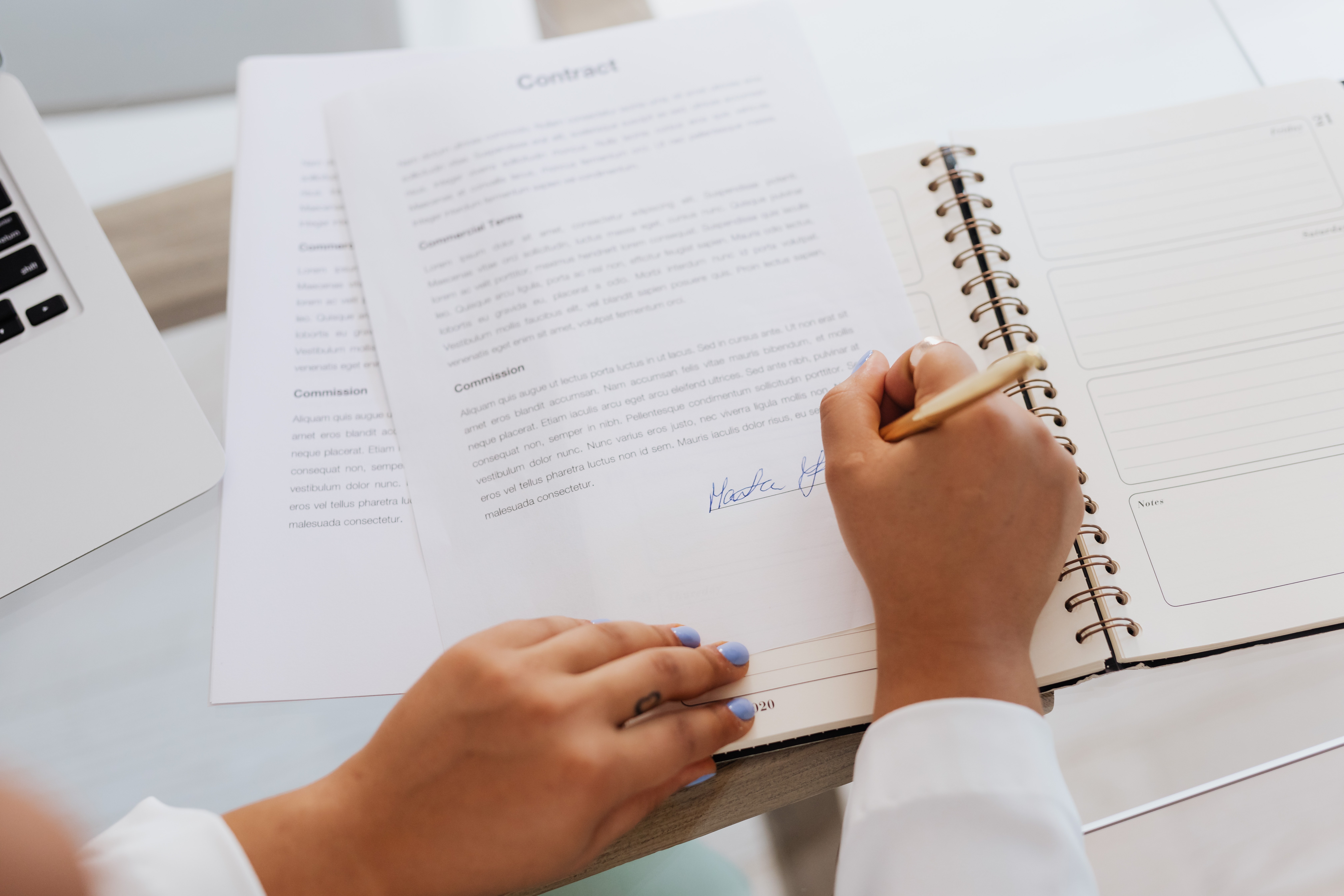 Woman signing contract; Photo by Karolina Grabowska from Pexels.com.