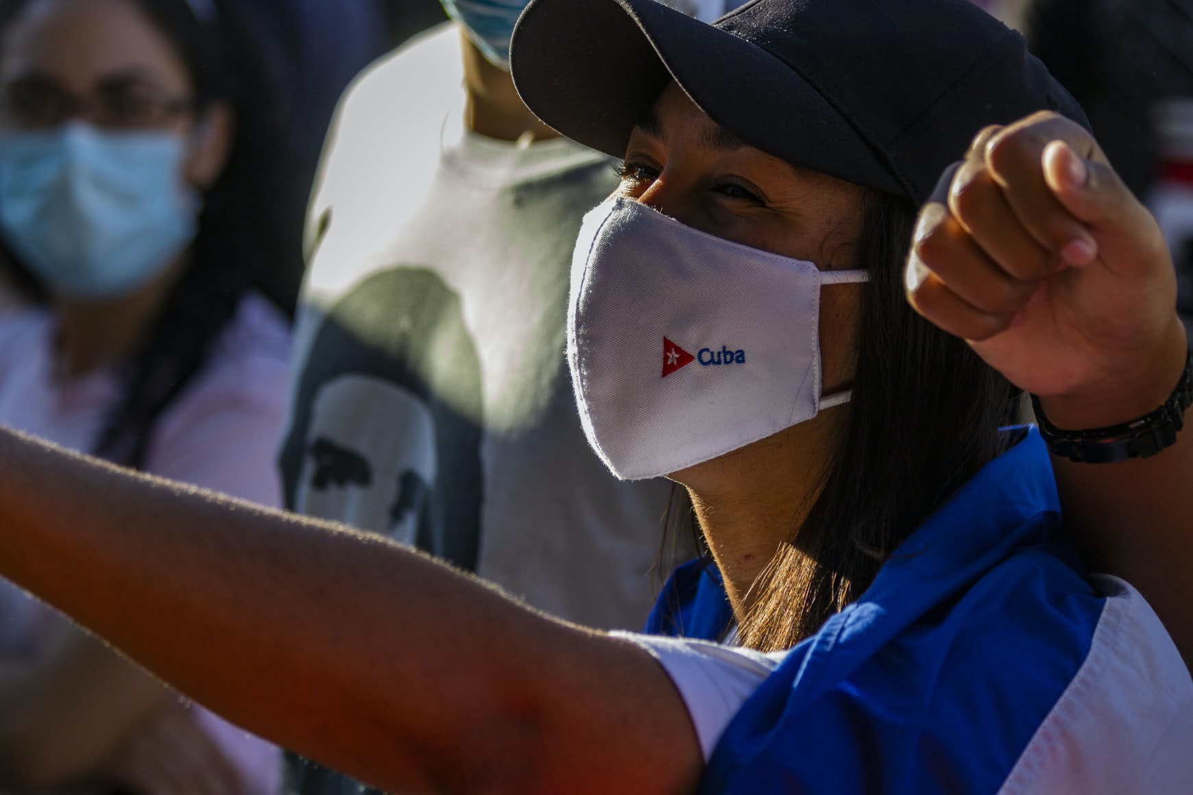 A woman wearing a face mask that says "Cuba".